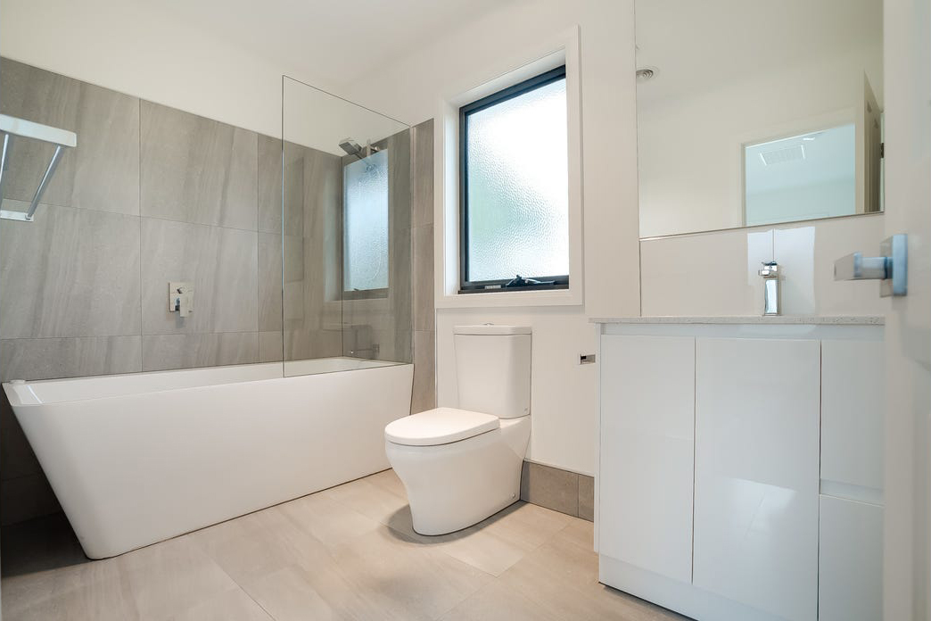 bathroom large all white with bathtub toilet and vanity