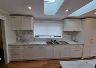 kitchen all white cabinetry and light wooden floor